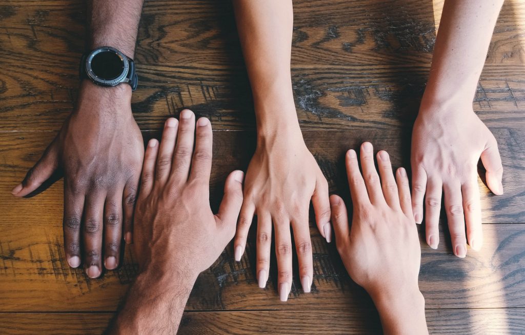 diverse hands across a table